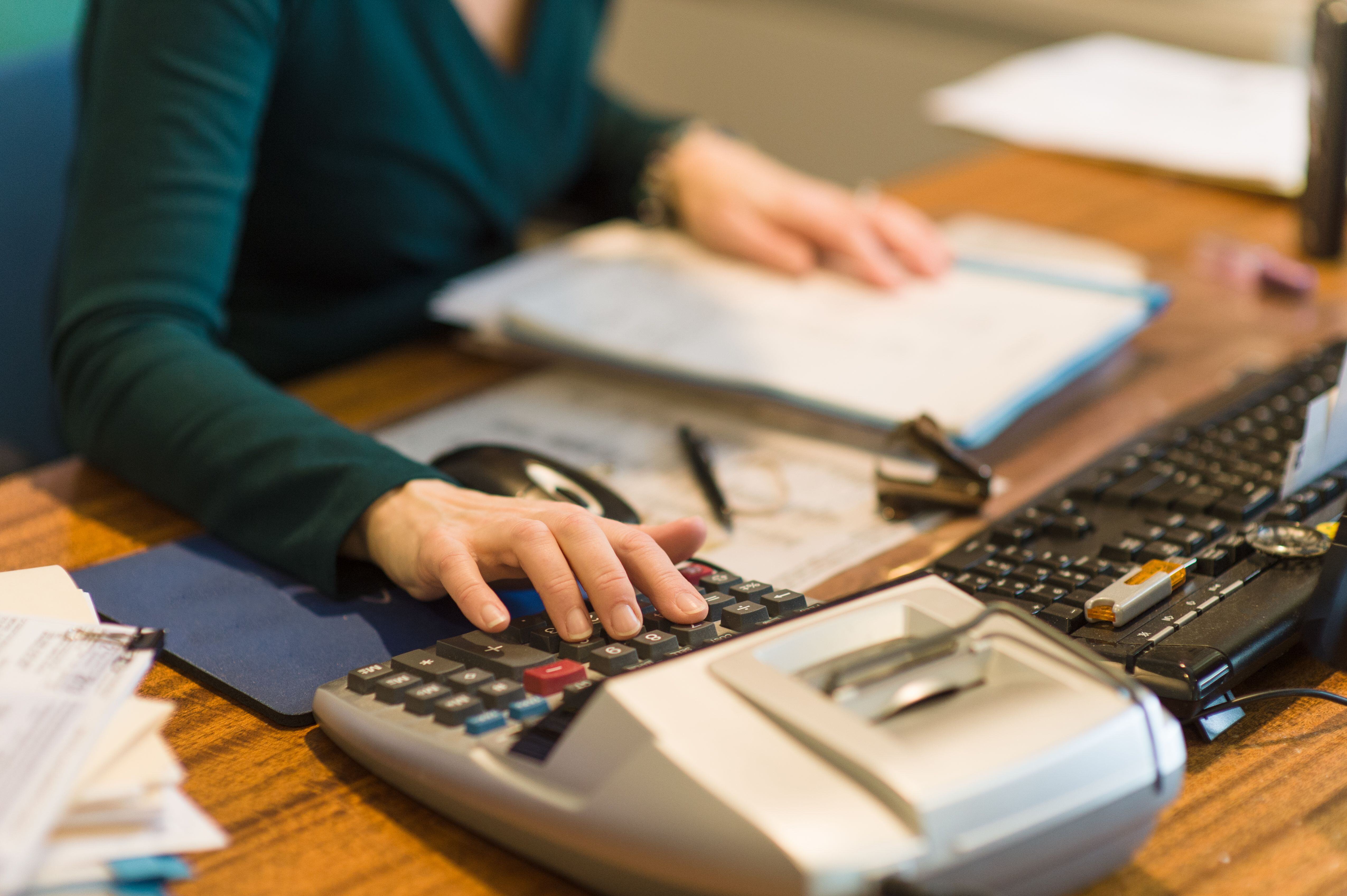female-accountant-keying-in-numbers-485846959-59d3cc75d088c000118417d9